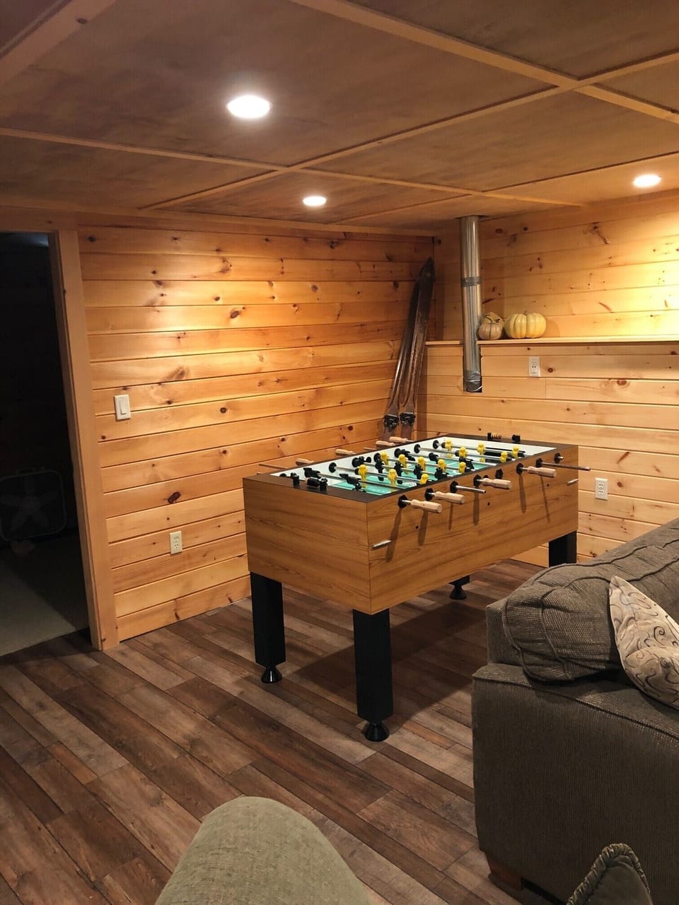 Finished basement with game area, TV, foosball table, bedroom and bath