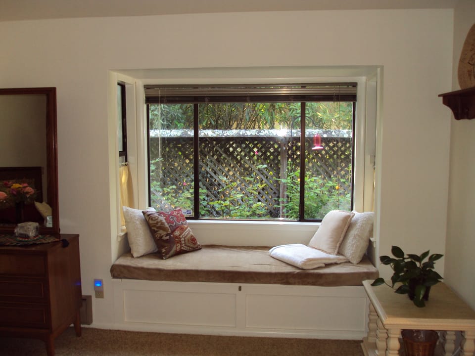 Master Bedroom: Snuggle up on the restful window seat overlooking the garden.