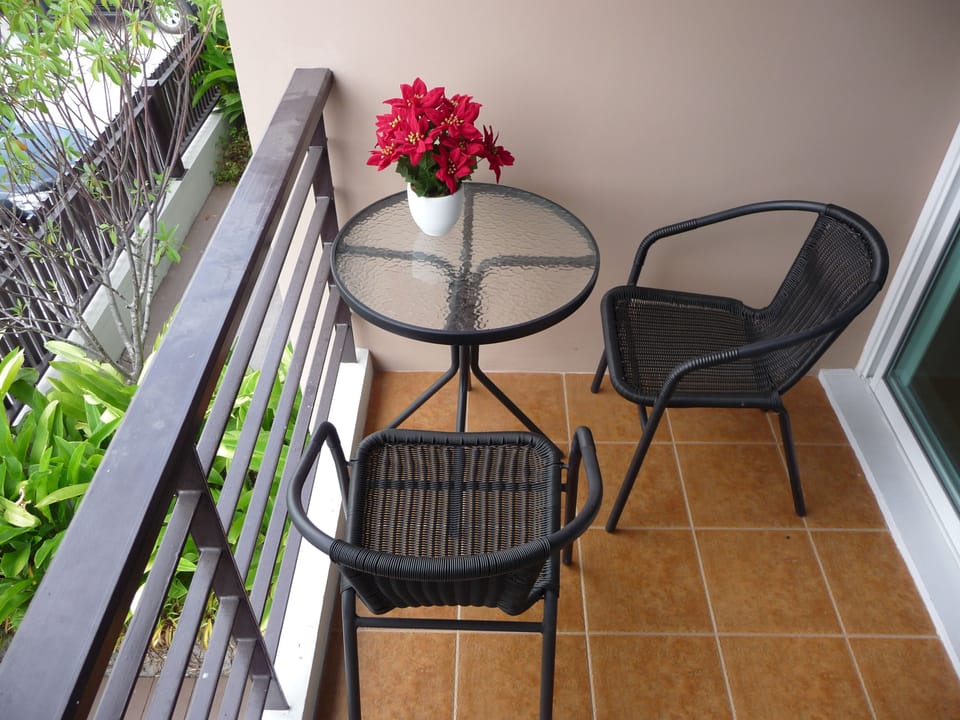 Balcony with garden set, ceiling fan, sun screen.