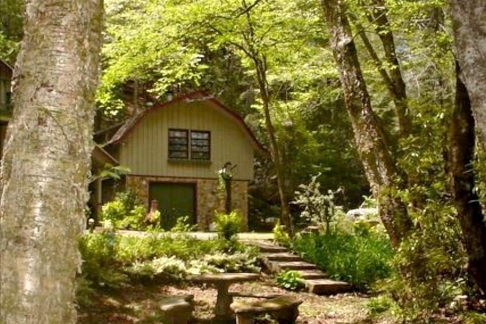Outside of cabin by Creek-side stairs up to covered porch on mountain side.
