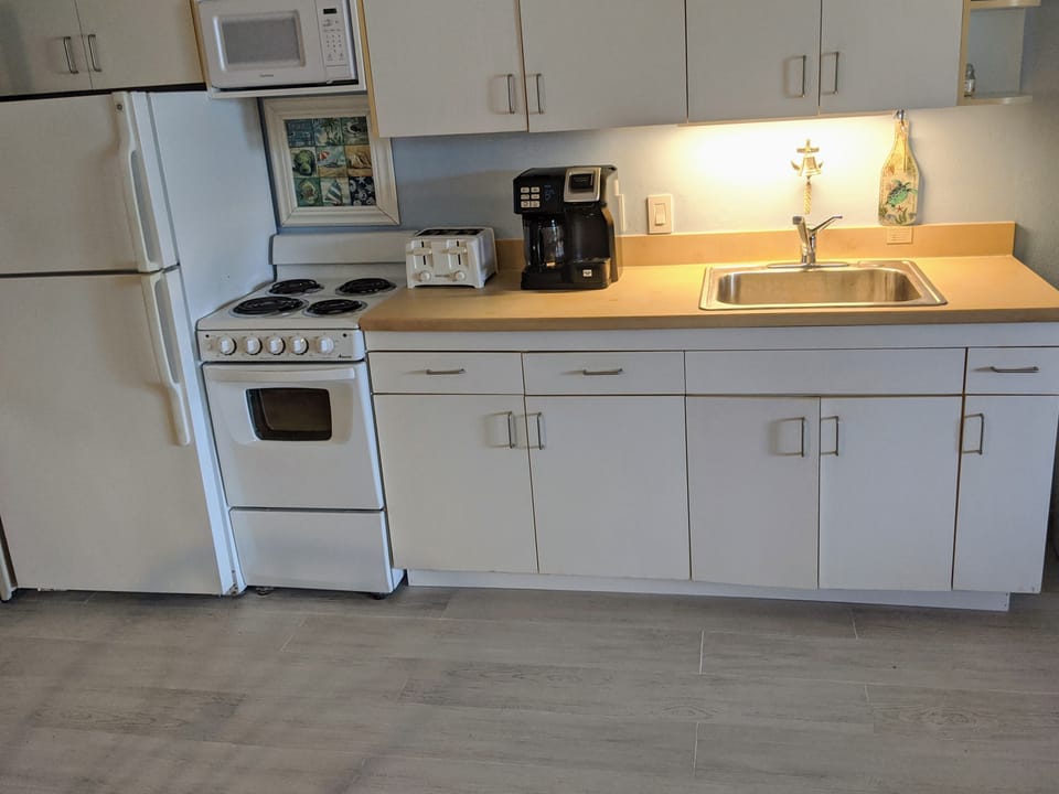 Kitchen with oven and new coffee maker, pods or pot