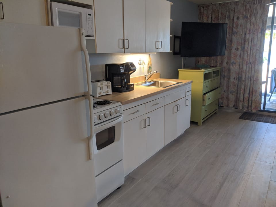 Kitchen area with new tile and new coffee maker and all essentials
