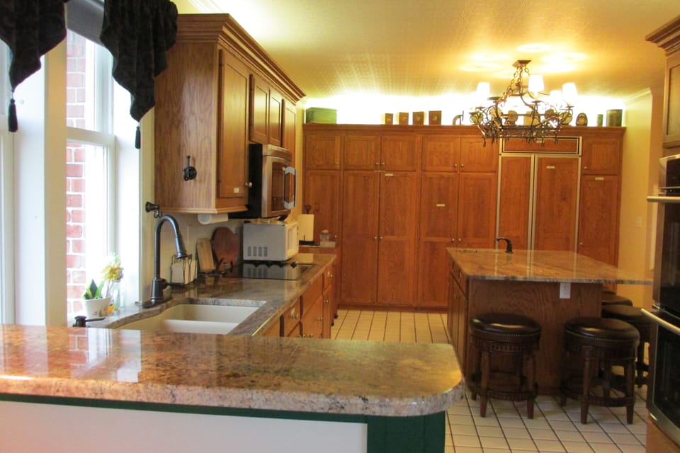 Being 'stuck' in the kitchen isn't so bad with a lake view and new granite!
