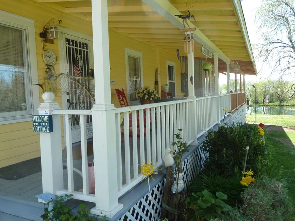 Charming front porch to sit on at night, listening to the frogs and crickets.