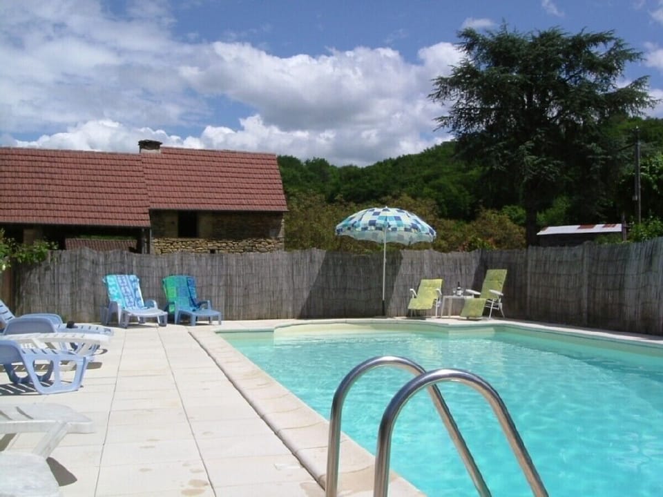 Private pool with covered games area beyond