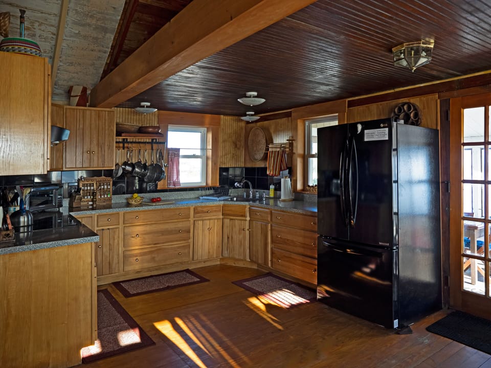Interior: spacious updated kitchen with large refrigerator, new appliances.