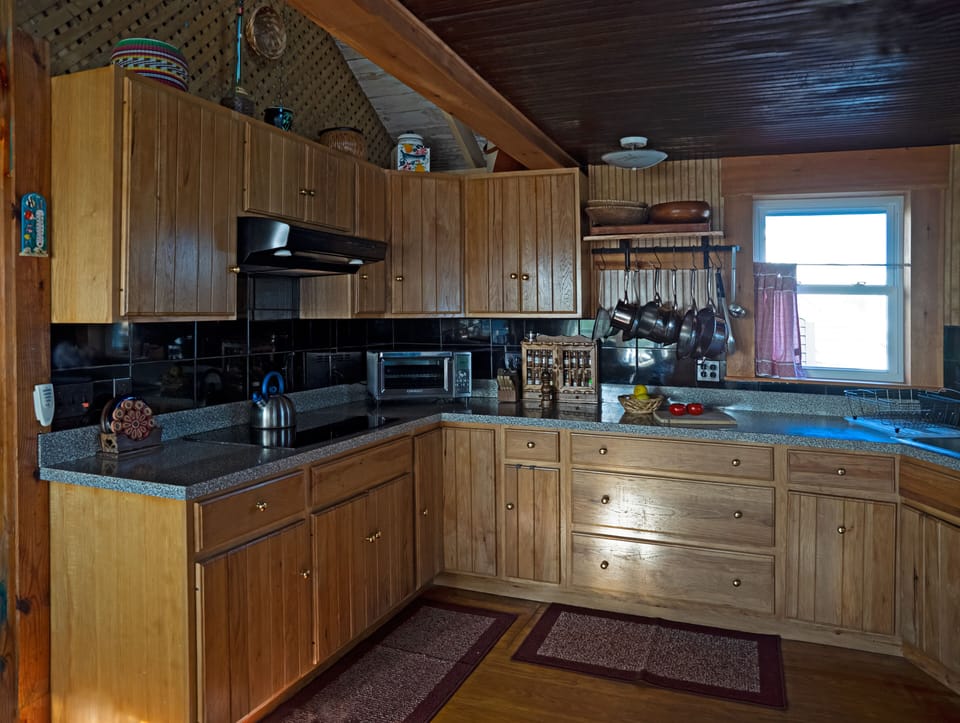 Kitchen: induction cooktop. Countertop oven can handle 12" pizza, roast chicken.