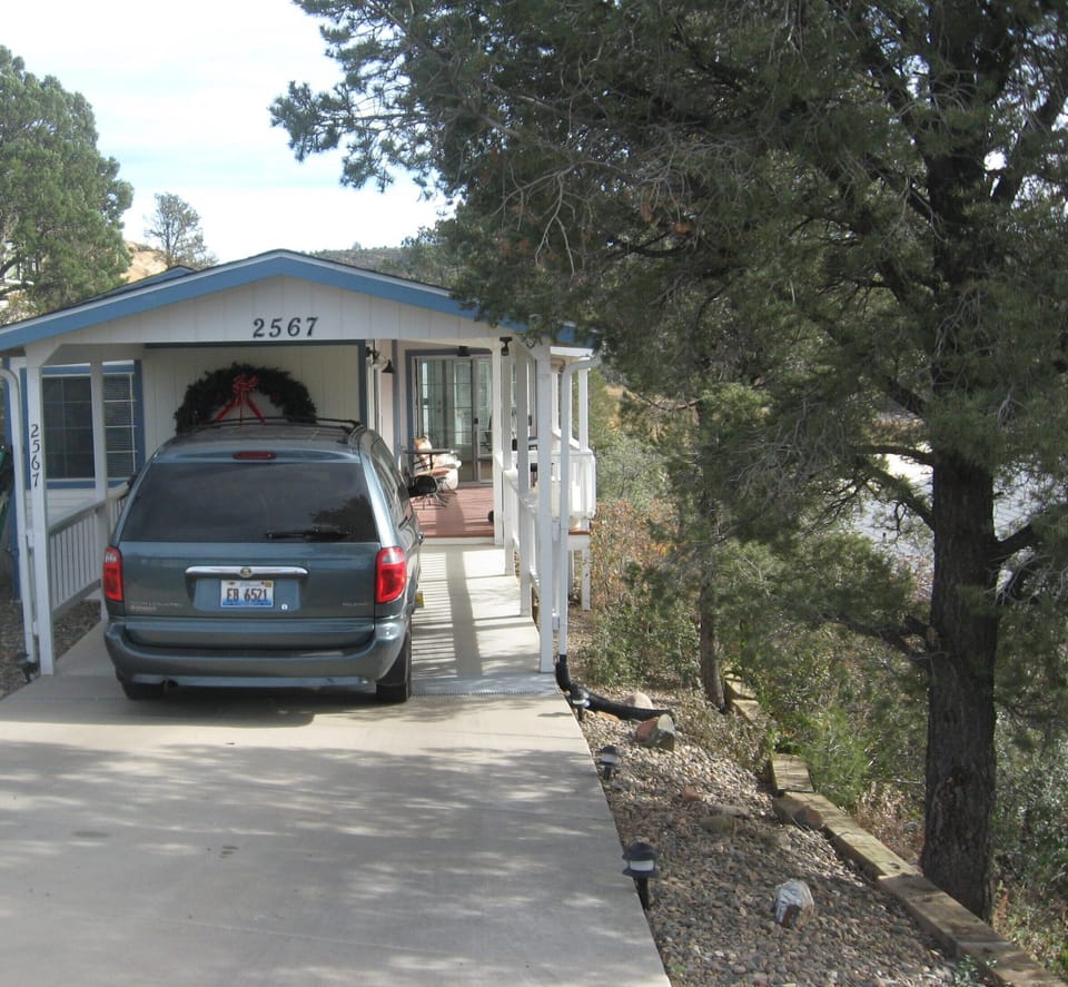 Cozy home tucked in the canyon wall with covered car port