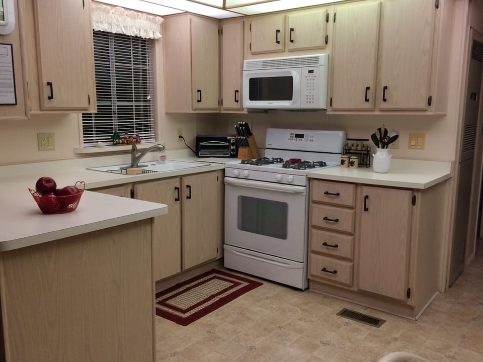 Modern kitchen with new gas stove, microwave, and dish washer