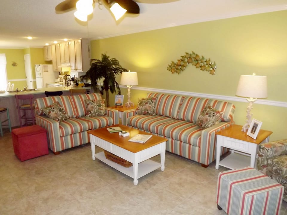 Third floor living area with love seat and queen sleeper sofa