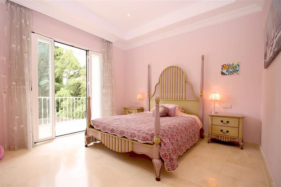 Third bedroom on the top floor with king-size bed, en-suite bathroom and access to the terrace