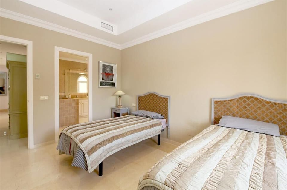 Fourth bedroom on the top floor with three single beds, en-suite bathroom and private terrace