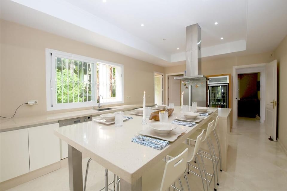 Kitchen with dining area for eight guests and laundry room to the rear