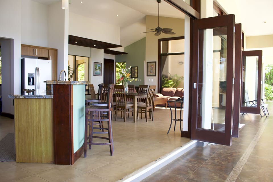 Kitchen -These extra-wide glass doors open up to let in refreshing ocean breezes