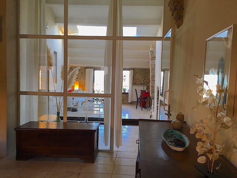 Looking from the upper master bedroom into the living area with large skylight