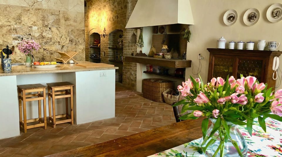 The kitchen — a working fireplace, marble island & meals to linger.
