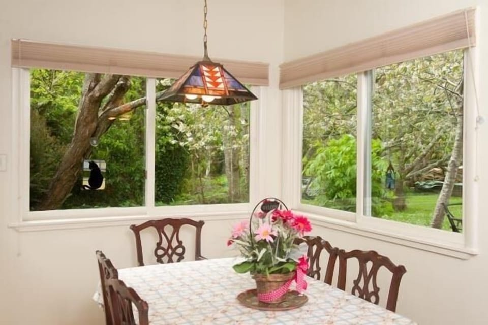The dining nook with a panoramic view of the garden and Francis Creek.