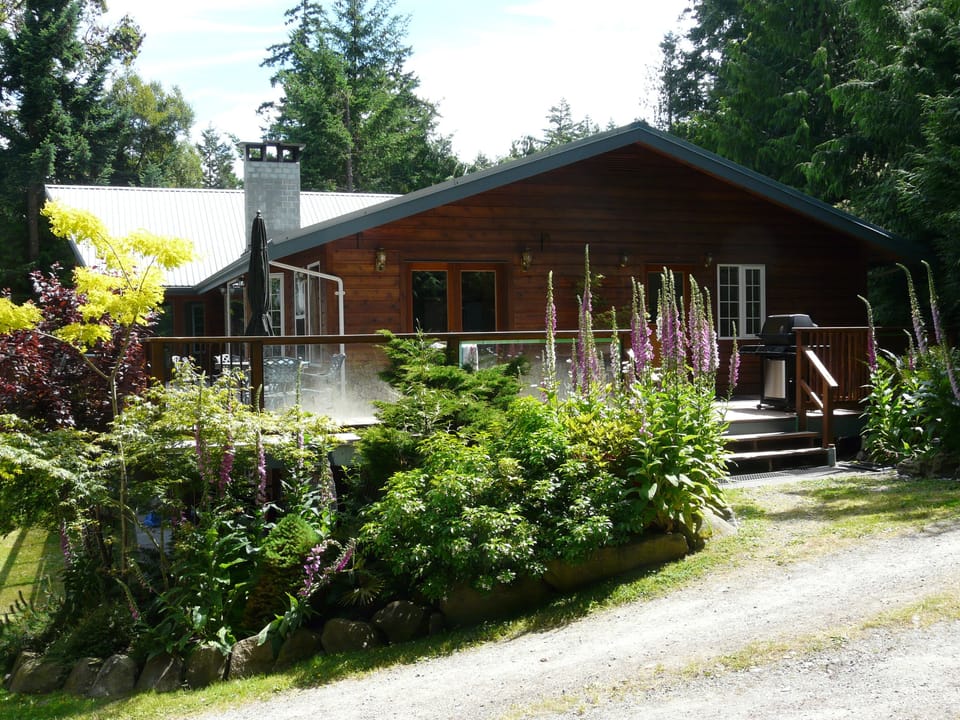 Entry of Saturna Seaside with deck,  BBQ and table-n-chairs