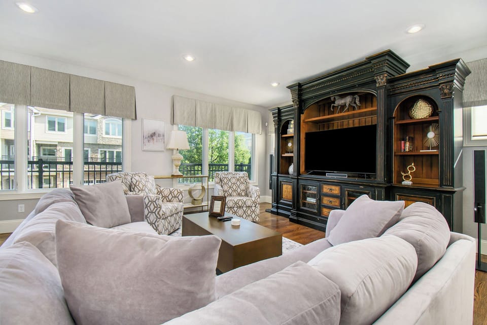 Fully remodeled upstairs living room with bar area and balcony.