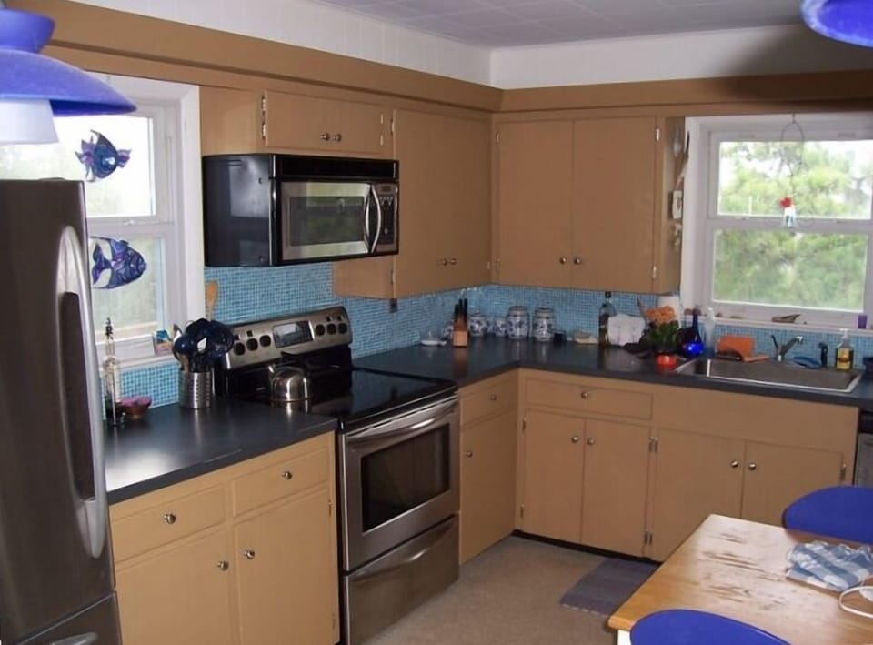 Kitchen with bar opens to dining room