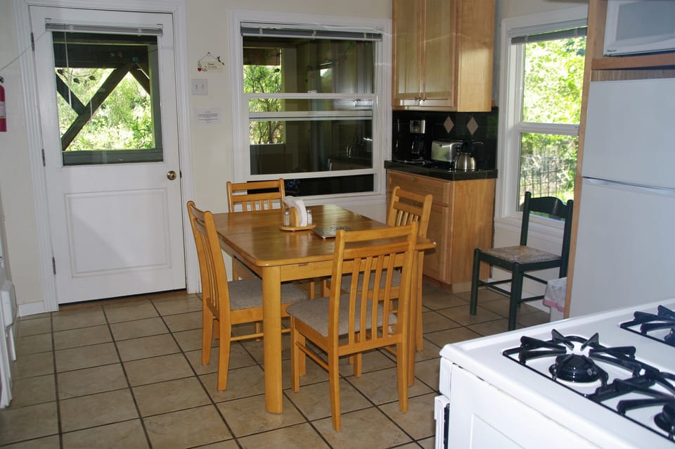 Dining area with door to covered porch and additional seating.