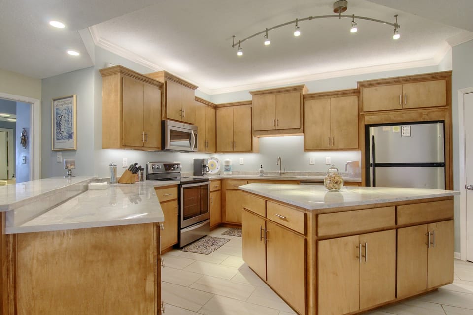 Large kitchen island with new appliances including under counter icemaker 