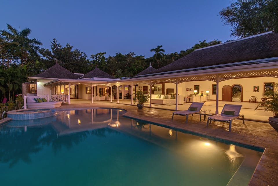 Pool at night looking into covered terrace and great room