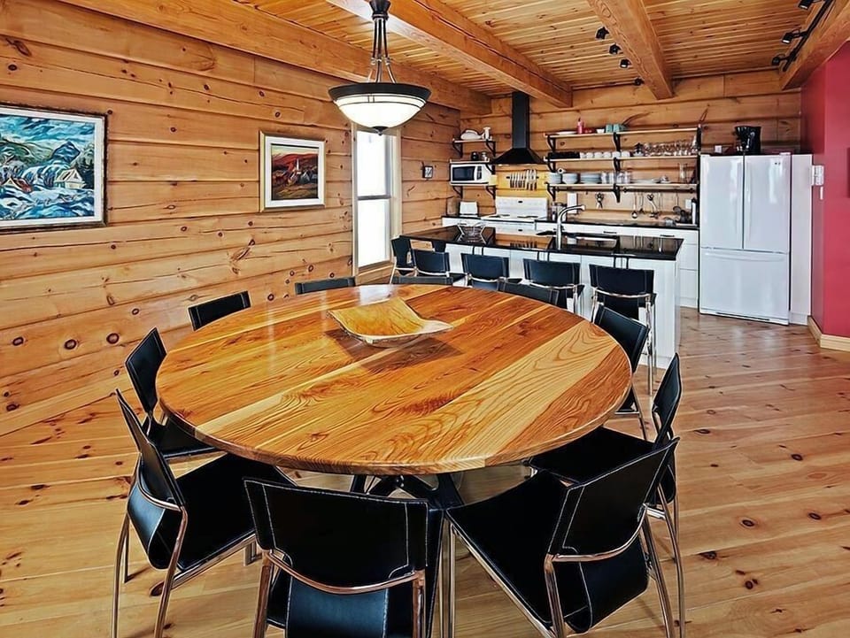 Home-made ash dining table and 10 comfy Italian leather chairs.