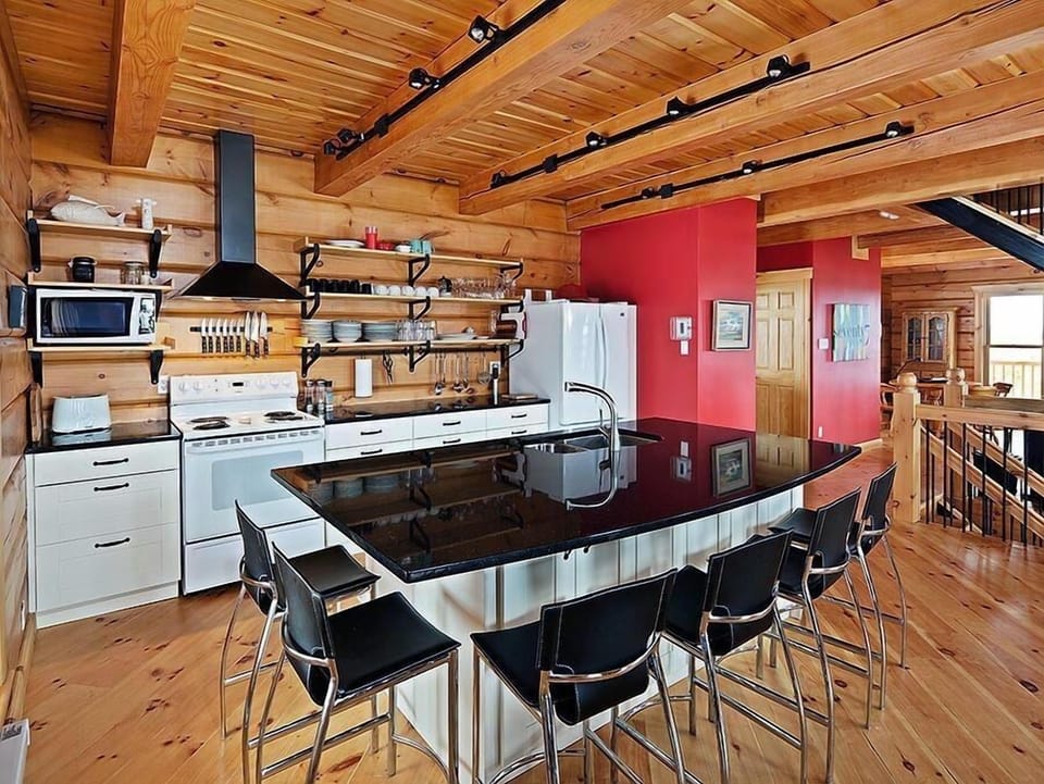 Kitchen: huge granite island with 6 comfy Italian leather stools- Party Central!