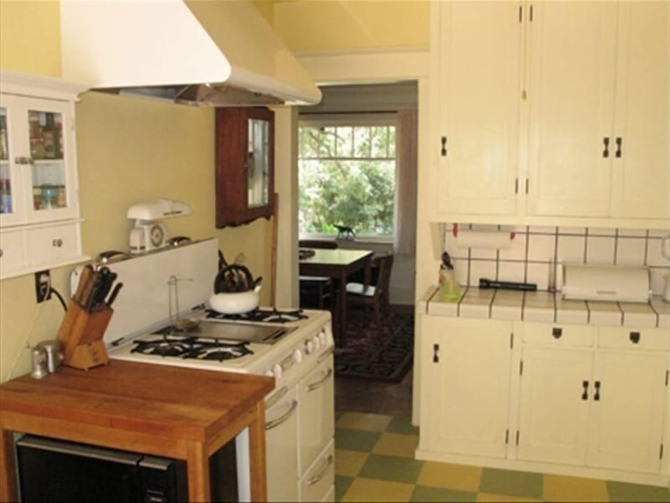 A Wedgewood stove and original cabinets grace the kitchen.