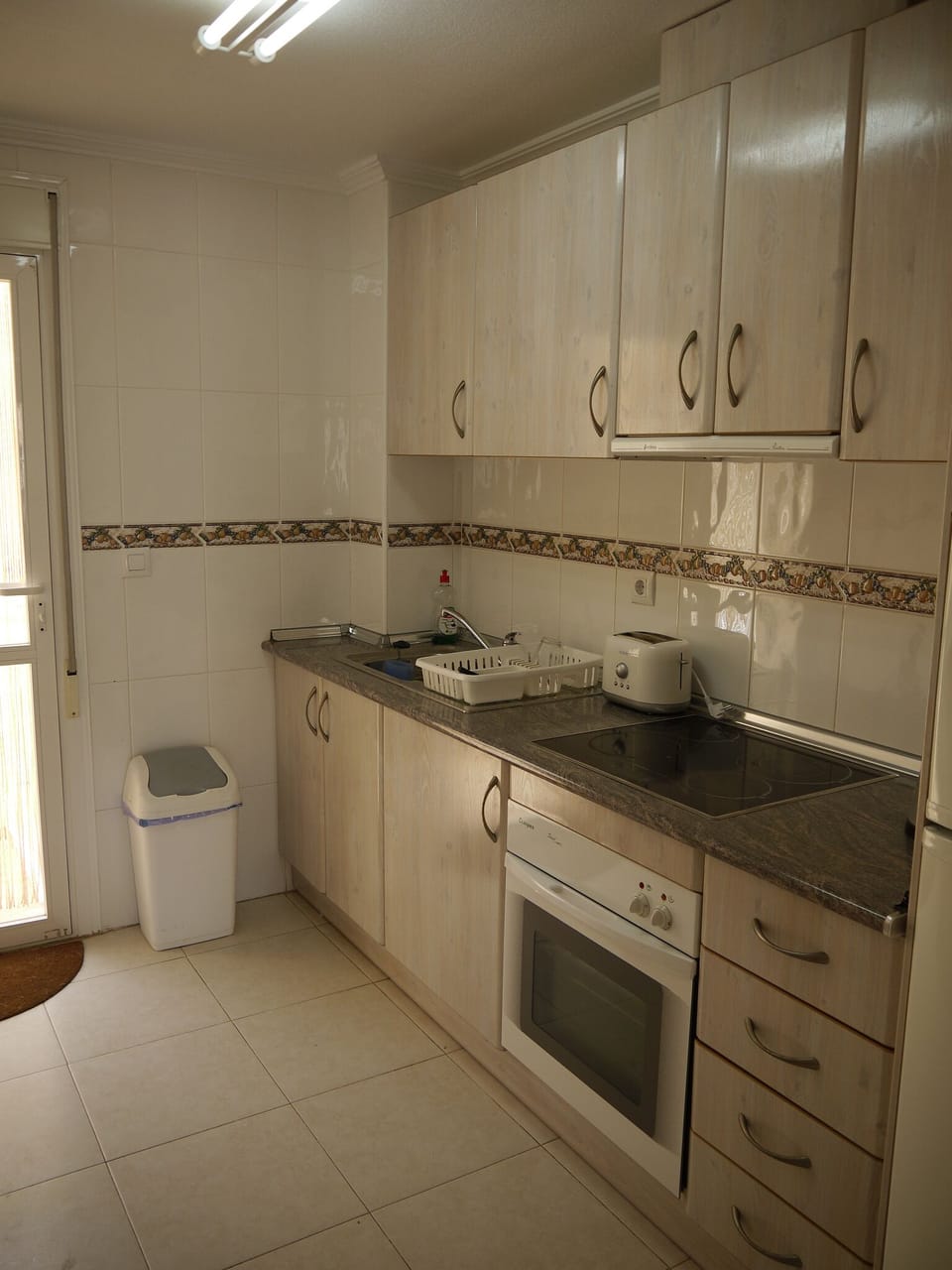 The kitchen area with door out to the rear patio and casita
