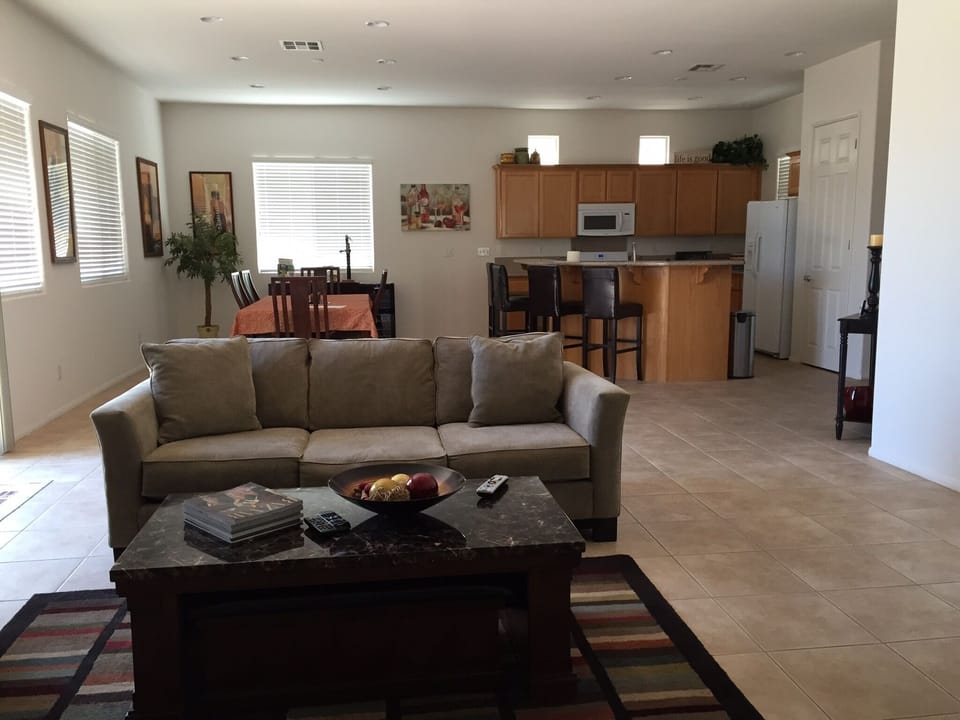 Looking back at the dining room and kitchen near the TV. 