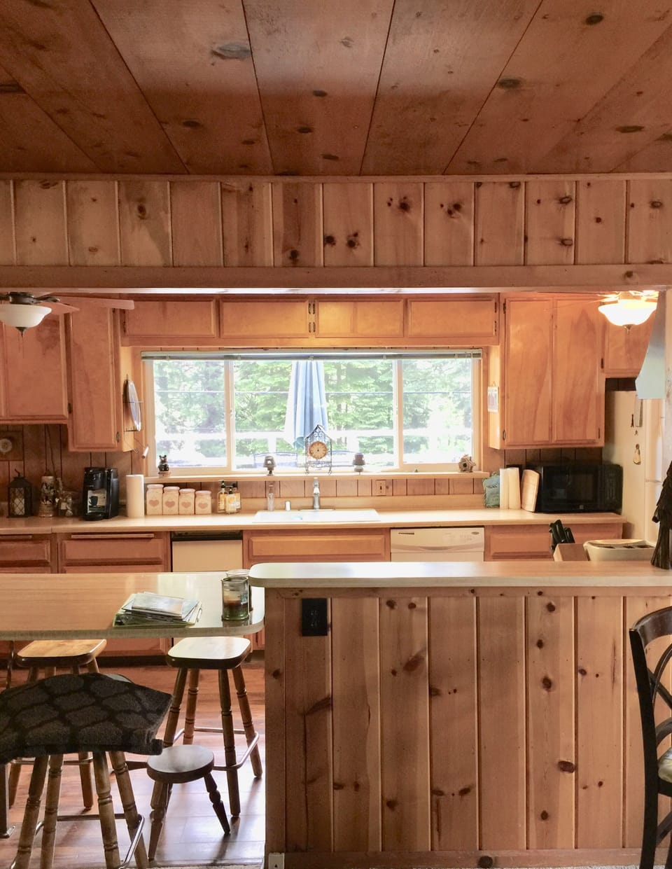 Kitchen window overlooking outdoor 2nd story balcony