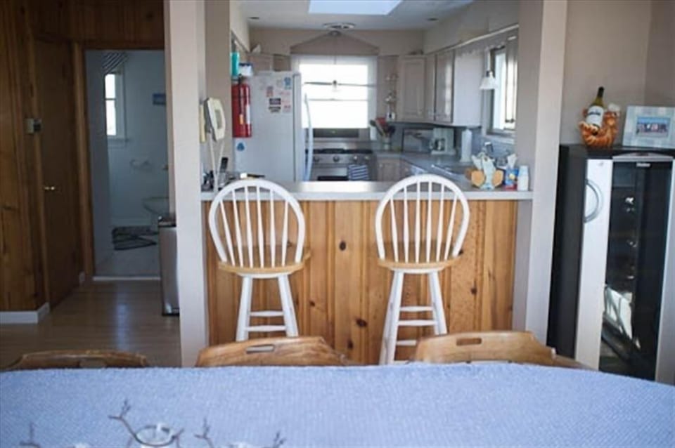 Kitchen view from dining table. On right is a separate beverage fridge.  