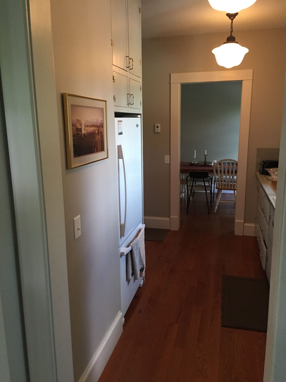 kitchen, full sink/counter to right, full gas stove just past fridge on left. 