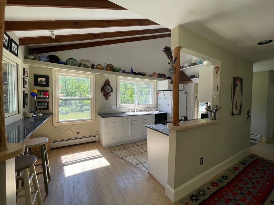 View into the open kitchen with cathedral ceilings.  