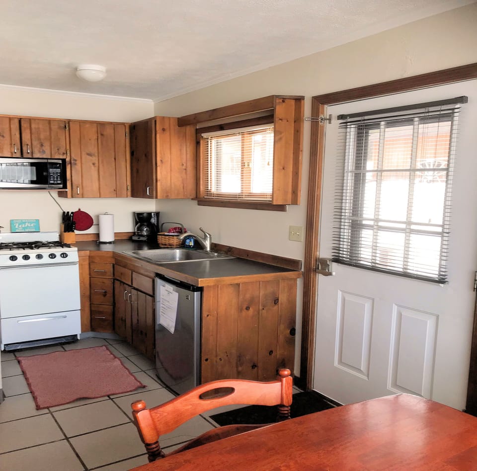 Cabin Six has a fully equipped kitchen including dishes, cookware, 