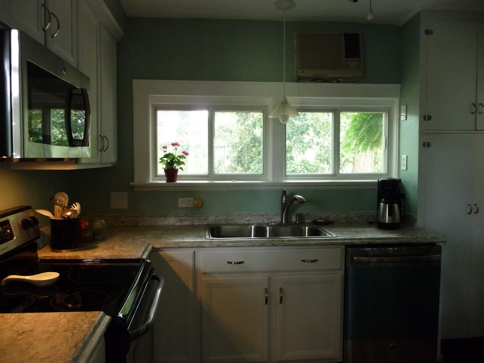 remodeled kitchen with microwave, dishwasher, range and refrigerator.