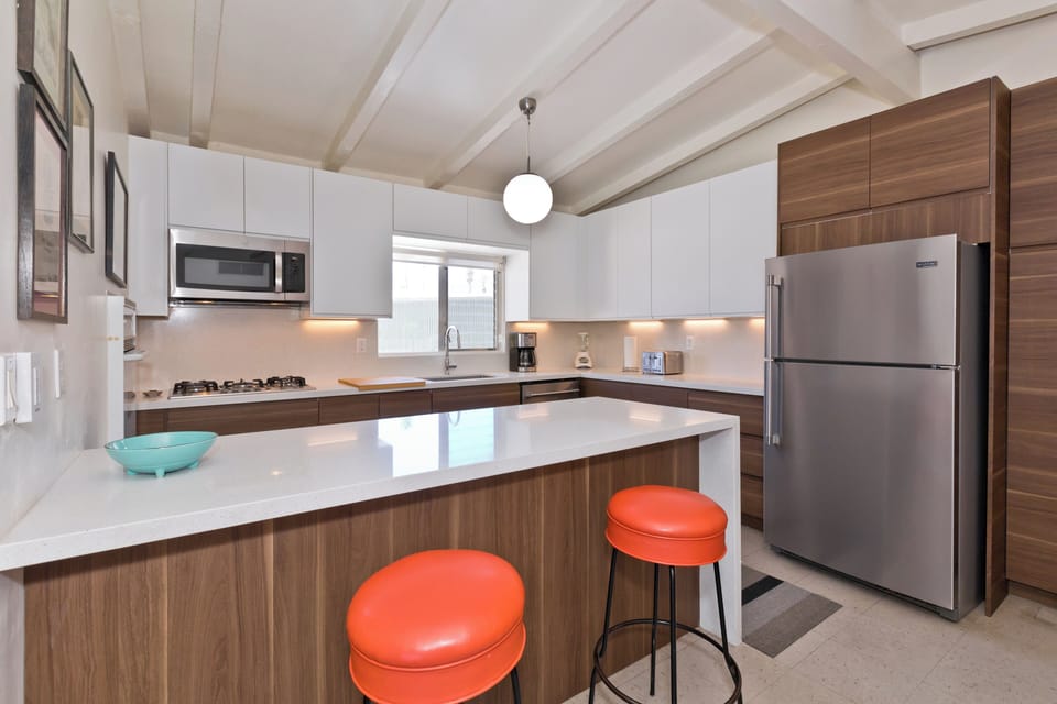 Modern kitchen still evokes the mid centure aesthetic of the home