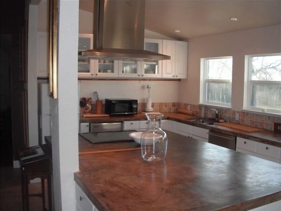 open and well-appointed kitchen with cement countertops