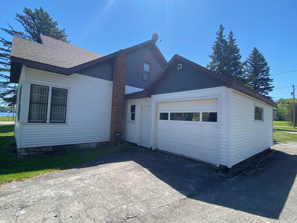 Four bedroom Glenwood house has attached garage.