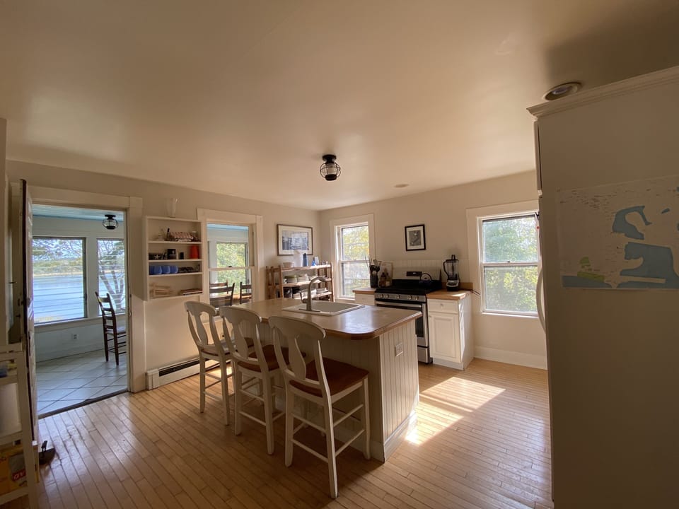 Kitchen opens to sunroom w/waterviews