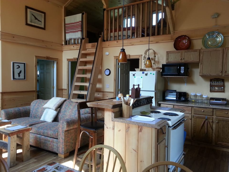 Open concept interior living space of the Golden Eagle cottage with upper loft