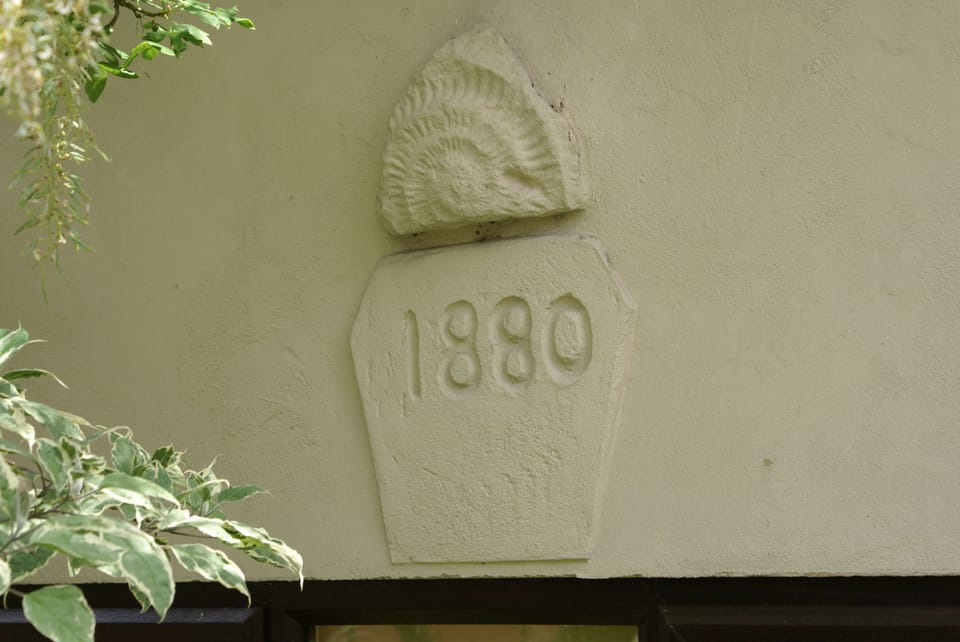 Wall plaque from the original outbuilding