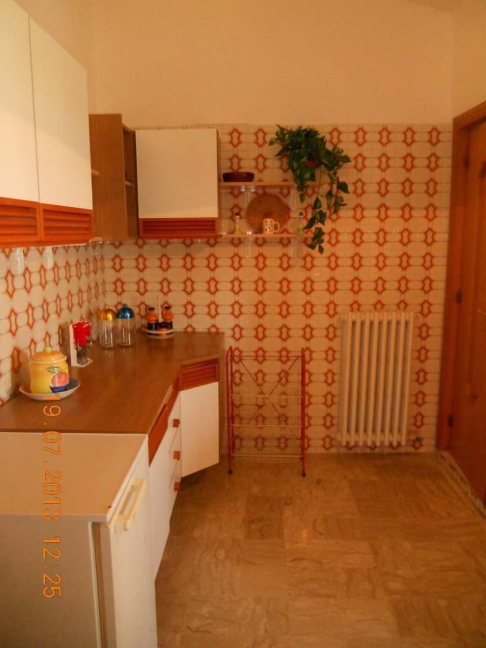 Left corner of the kitchen.