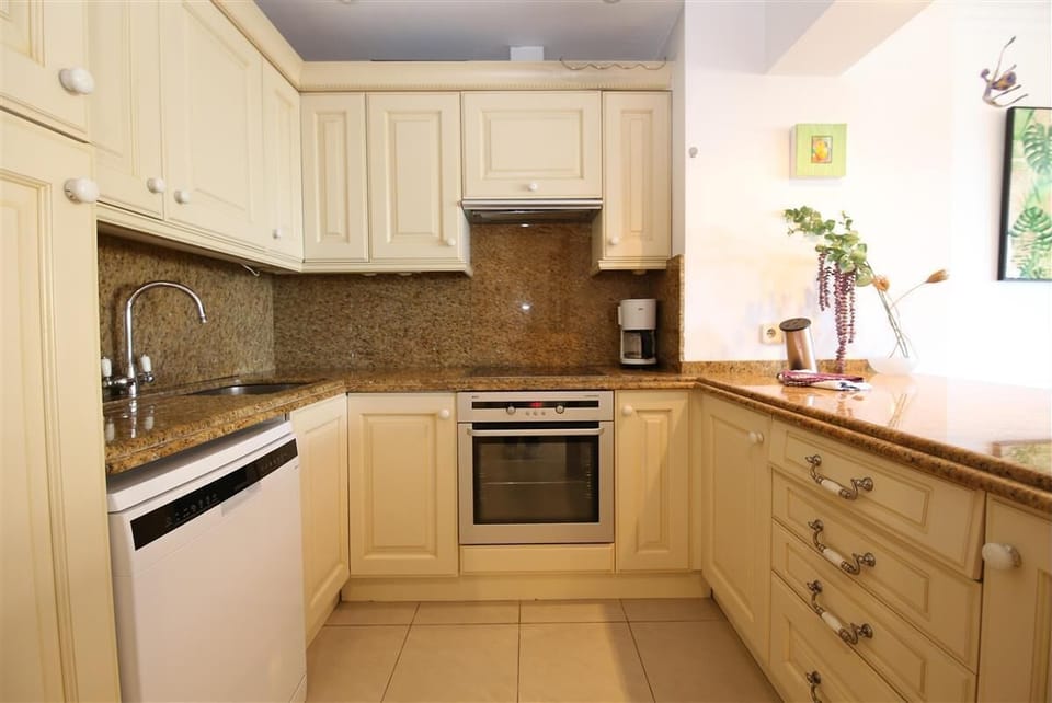Kitchen in this apartment is fully equipped with all the appliances