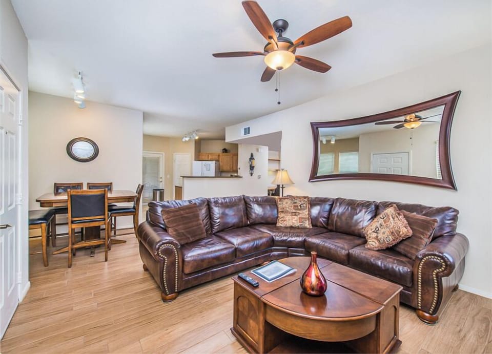 Leather lounge suite, fireplace, ceiling fan, art décor mirror, tiled floors