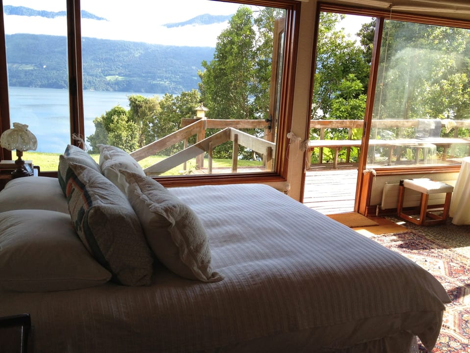 Master bedroom has spectacular wrap-around lake views, fireplace & en suite bath