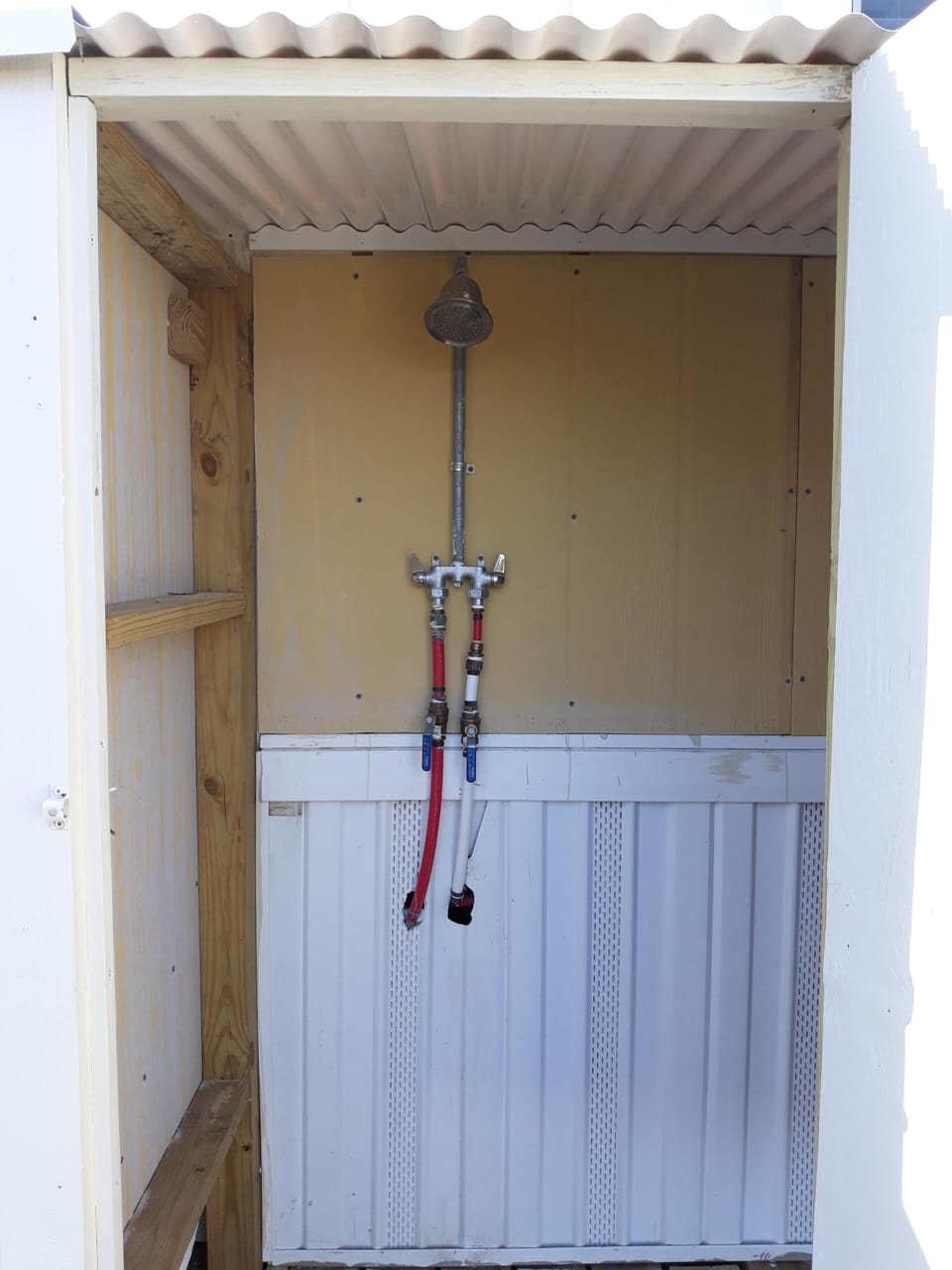 Enclosed outdoor shower with hot/cold water
