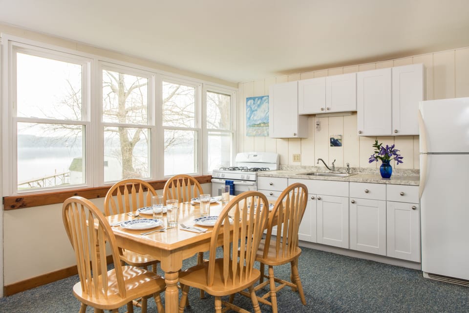 Downstairs kitchen/dining/living room with 12 windows overlooking the lake